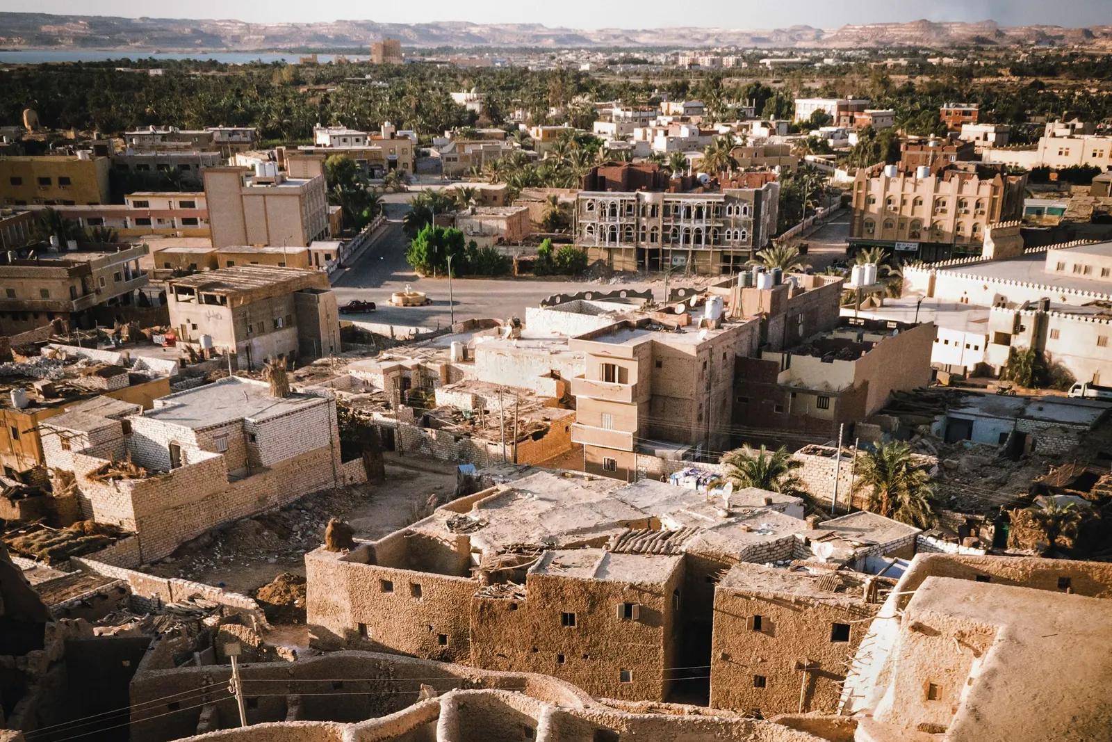 A notebook and map beside warm Egyptian landscape photography