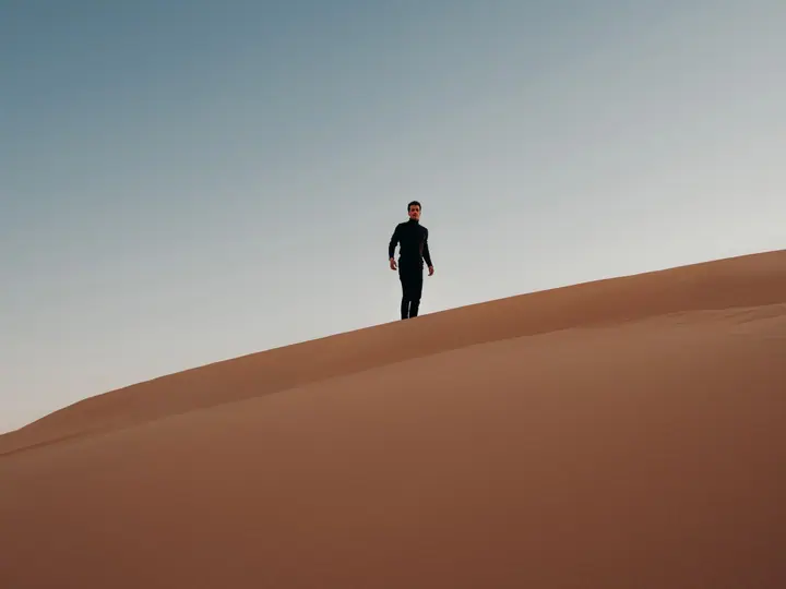 Wind-shaped dunes beneath a clear sky in Egypt