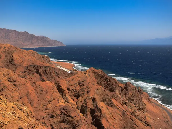 Clear blue water and dry coastal mountains in Sinai